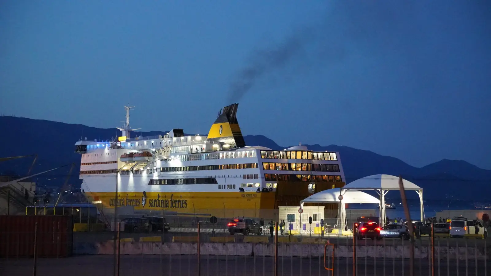 The cruise ferry Mega Express Four from Corsica Ferries docks in the port of Savona in the evening.