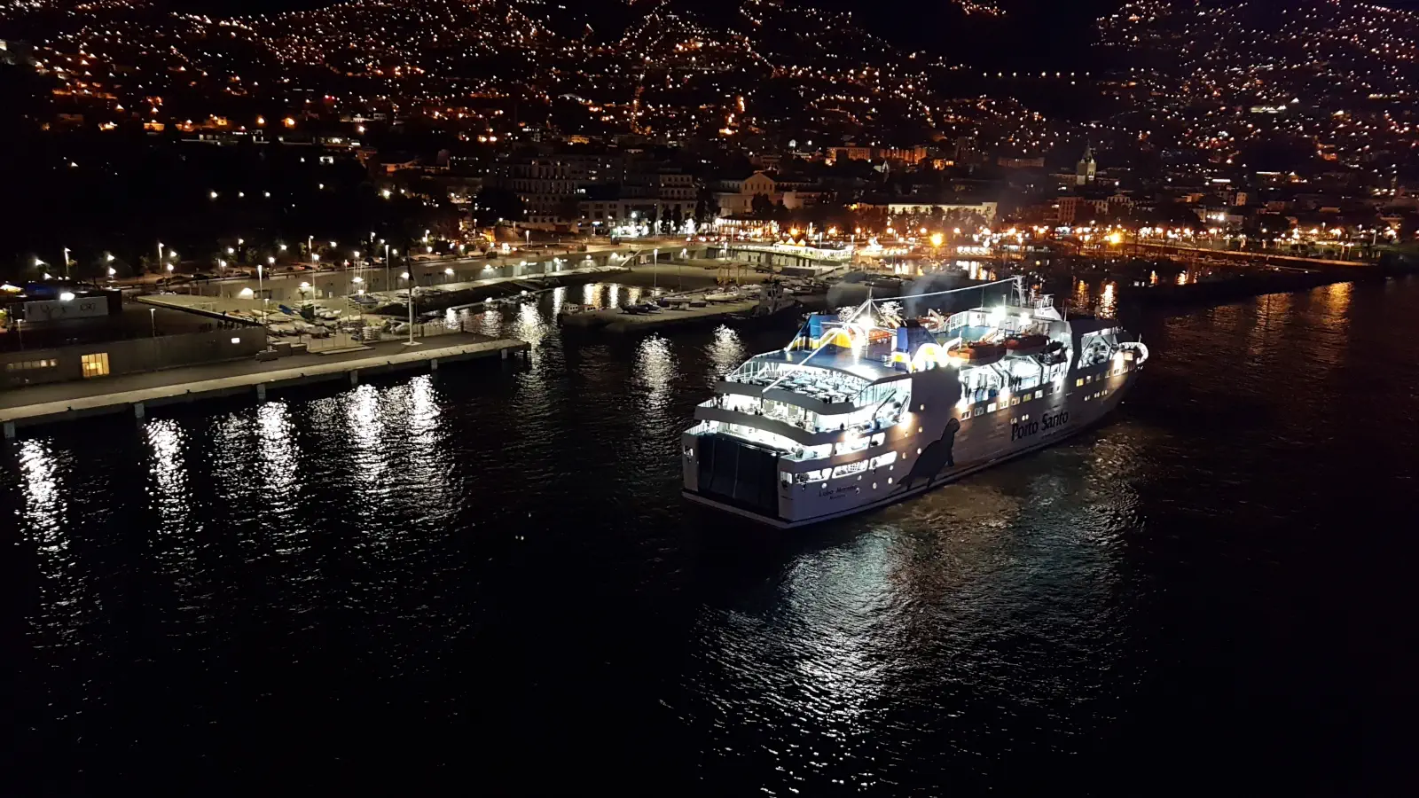 The Porto Santo Line's Ferry Lobo Marinho arrives in the port of Funchal on Madeira in the evening.